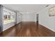 Sunlit living room with hardwood floors and large windows offering picturesque neighborhood views at 1812 Se 38Th Ave, Ocala, FL 34471
