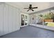 This expansive screened porch with a ceiling fan provides access to both the home and backyard at 1812 Se 38Th Ave, Ocala, FL 34471