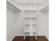 Bright walk-in closet featuring hardwood floor and a built-in shelving unit at 1812 Se 38Th Ave, Ocala, FL 34471