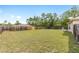 Large, private fenced backyard featuring a lush lawn, providing plenty of room for and pets to play at 2 Hemlock Trace Run, Ocala, FL 34472