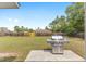 Large, grassy backyard with a stainless steel grill, perfect for outdoor entertaining at 2 Hemlock Trace Run, Ocala, FL 34472