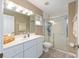 Bathroom with tile floors, a glass shower, and vanity with a white countertop at 2 Hemlock Trace Run, Ocala, FL 34472
