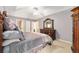 Bedroom with matching dresser and mirror in neutral colors and tray ceiling at 2 Hemlock Trace Run, Ocala, FL 34472