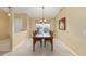 Inviting dining room with ample lighting and a classic wooden dining set for Gathering gatherings at 2 Hemlock Trace Run, Ocala, FL 34472