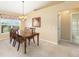 Dining room featuring a wooden table set with chairs and bright light from a window at 2 Hemlock Trace Run, Ocala, FL 34472