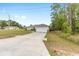 Charming single-Gathering home with a two-car garage and a long driveway, complemented by a well-manicured front lawn at 2 Hemlock Trace Run, Ocala, FL 34472