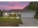 Charming single-story home with a two-car garage and well-maintained front yard with landscaping at 2 Hemlock Trace Run, Ocala, FL 34472