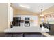 Open kitchen with a breakfast bar, black appliances, and white cabinets offers seamless living at 2 Hemlock Trace Run, Ocala, FL 34472