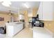 Bright kitchen with white cabinets, a stainless steel dishwasher, and views into the dining area at 2 Hemlock Trace Run, Ocala, FL 34472