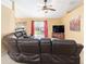 Living room showcasing a ceiling fan, a television, and a sliding glass door to the backyard at 2 Hemlock Trace Run, Ocala, FL 34472