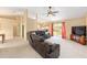 Open-concept living room featuring an entertainment center and sliding glass doors at 2 Hemlock Trace Run, Ocala, FL 34472