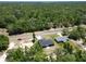 A bird's-eye view showcasing two homes nestled in a wooded area, with a road providing easy access at 22777 Sw Beach Blvd, Dunnellon, FL 34431