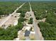 New construction homes are nestled on a lot with mature trees along a rural road at 22777 Sw Beach Blvd, Dunnellon, FL 34431