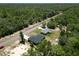This aerial view shows two homes nestled among trees along a road, offering both seclusion and accessibility at 22777 Sw Beach Blvd, Dunnellon, FL 34431
