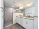 This bathroom features double sinks with granite counters, modern fixtures, and a tiled walk-in shower at 22777 Sw Beach Blvd, Dunnellon, FL 34431