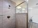 Stylish bathroom featuring a sleek, tiled walk-in shower with glass partition and a glimpse of the toilet at 22777 Sw Beach Blvd, Dunnellon, FL 34431