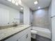Bathroom with tile flooring, granite counters, and tiled shower and tub at 22777 Sw Beach Blvd, Dunnellon, FL 34431