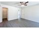 Bright and airy bedroom with a ceiling fan, a walk-in closet, and light gray wood-look floors at 22777 Sw Beach Blvd, Dunnellon, FL 34431