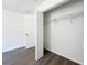 A closet with open door, white shelving, and hardwood floors at 22777 Sw Beach Blvd, Dunnellon, FL 34431