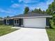 Well-maintained single-Gathering home with a two-car garage and a pristine, freshly paved driveway at 22777 Sw Beach Blvd, Dunnellon, FL 34431