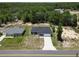 A quaint new home with a gray roof and clean landscaping boasts a large driveway at 22777 Sw Beach Blvd, Dunnellon, FL 34431