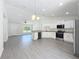 Bright interior features granite countertops, modern stainless appliances, and gray wood-look flooring at 22777 Sw Beach Blvd, Dunnellon, FL 34431