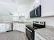 Bright modern kitchen with granite countertops and stainless steel appliances at 22777 Sw Beach Blvd, Dunnellon, FL 34431