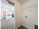 Laundry room located off the kitchen with white walls and wire rack shelf at 22777 Sw Beach Blvd, Dunnellon, FL 34431
