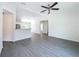 Open-concept living room showcases modern flooring and provides seamless kitchen access at 22777 Sw Beach Blvd, Dunnellon, FL 34431