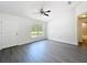 Clean living room featuring modern flooring, a window for natural light and a white front door at 22777 Sw Beach Blvd, Dunnellon, FL 34431