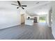 Open-concept living room showcases modern flooring, abundant light and provides seamless kitchen access at 22777 Sw Beach Blvd, Dunnellon, FL 34431