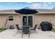 Backyard patio featuring an umbrella, table, and grill, perfect for outdoor gatherings at 2690 Sw 154Th Ln, Ocala, FL 34473