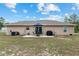 Backyard featuring a patio with an umbrella, table, and grill, perfect for entertaining guests at 2690 Sw 154Th Ln, Ocala, FL 34473