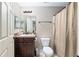 Bathroom featuring a vanity with a sink, mirror, toilet, and a shower with neutral shower curtain at 2690 Sw 154Th Ln, Ocala, FL 34473