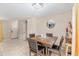 Warm dining room with dark wood table and chairs, neutral walls, and a view to the front door at 2690 Sw 154Th Ln, Ocala, FL 34473