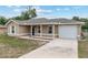 Charming single-story home featuring a cozy porch, neutral-toned exterior, and attached one-car garage at 2690 Sw 154Th Ln, Ocala, FL 34473