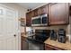 This kitchen features granite counters, dark wood cabinets, and stainless steel appliances at 2690 Sw 154Th Ln, Ocala, FL 34473