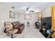 Comfortable living room with neutral-toned walls, tile floors, a ceiling fan, and an entertainment center at 2690 Sw 154Th Ln, Ocala, FL 34473
