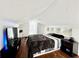 Well-lit bedroom with wood flooring, white walls, a sloped ceiling, and recessed shelving at 3005 Ne 19Th Ave, Ocala, FL 34479
