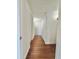 Hallway with beautiful wood flooring, white walls, and plenty of storage space at 3005 Ne 19Th Ave, Ocala, FL 34479