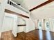 Bright open-concept living room featuring wood-look flooring, exposed beams, and staircase to loft at 3005 Ne 19Th Ave, Ocala, FL 34479