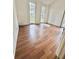 Bright living room featuring wood-look flooring, white walls, and sun-drenched windows at 3005 Ne 19Th Ave, Ocala, FL 34479