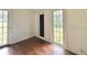 Bright, empty living room with hardwood floors and white trim has lots of natural light at 3005 Ne 19Th Ave, Ocala, FL 34479