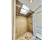 Tiled shower featuring a rainfall showerhead and skylight at 3005 Ne 19Th Ave, Ocala, FL 34479