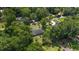 Lush greenery surrounds this cozy single story home with a dark roof and outdoor living space at 3880 Sw 6Th Ave, Ocala, FL 34471