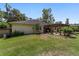 A home's backyard featuring a pergola covered patio with furniture at 3880 Sw 6Th Ave, Ocala, FL 34471