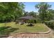 Expansive backyard with a wooden pergola-covered patio, well-maintained lawn, and mature trees, creating a serene outdoor space at 3880 Sw 6Th Ave, Ocala, FL 34471
