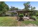 A home's backyard with a pergola covered patio and well maintained lawn at 3880 Sw 6Th Ave, Ocala, FL 34471