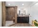 Bathroom featuring wood-look tiled shower, granite vanity, and modern finishes at 3880 Sw 6Th Ave, Ocala, FL 34471