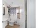 Bathroom with a pedestal sink, tub with shower, and decorative blue shower curtain at 3880 Sw 6Th Ave, Ocala, FL 34471